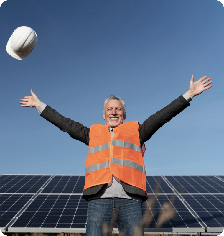 John Standing Infront of solar panel and spreading his hands