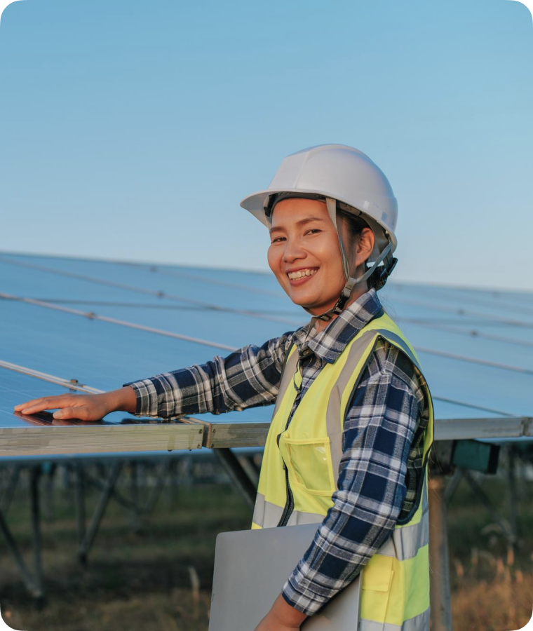 Sarah standing besides of solar panel and touching it with her hands